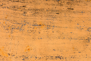 Textured background of a faded yellow paint with rusted cracks on rusted metal. Grunge texture of an old cracked metal surface. Rusty yellow-red stains
