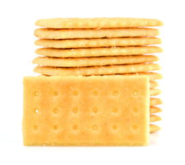 Salty crackers in square shape on white background