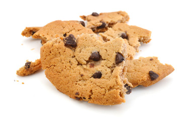 Close up of an half eaten cookie with crumb against a white background
