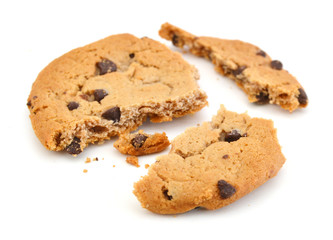 Close up of an half eaten cookie with crumb against a white background