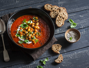 Gazpacho soup with spicy fried chickpeas on a dark background. Vegetarian healthy food diet weight loss concept