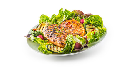 Chicken breast. Grill chicken breast with lettuce salad zucchini and radish isolated on white