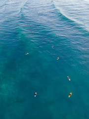 Aerial view of group of surfers waiting for wave.