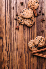 oatmeal cookies with chocolate on a wooden background