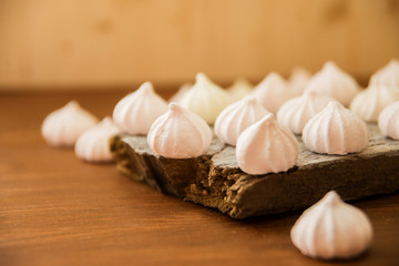 lots of little meringues on dark wooden background