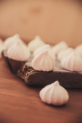 lots of little meringues on dark wooden background