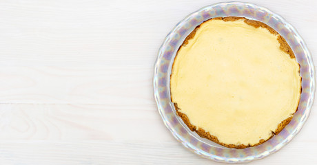 Cheesecake on white wooden table. Top view. Copy space.
