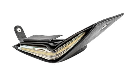 Opened black wallet with money isolated on white.