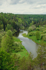 The blue ribbon of the river from the height of the mountains. Wild nature, taiga. Tourism. Far East, Sakhalin Island, Russia.