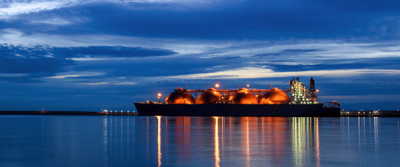 LNG TANKER AT THE GAS TERMINAL - Sunrise over the ship and port
