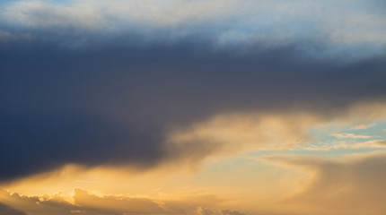 Beautiful stormy moody cloudy sky over English countryside landscape at dusk