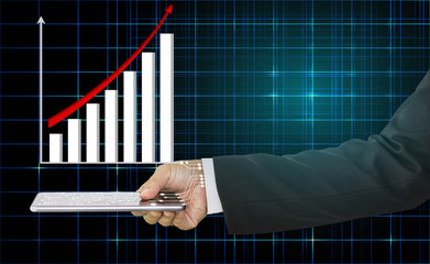 Businessman hand holding mobile phone and the graph is shown above with red arrow indicates economic, concept of technology and growth of business