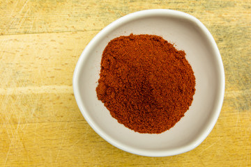 A small bowl of smoked paprika. View from above.