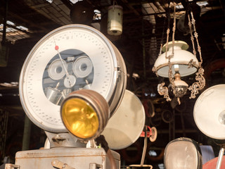 Antiquarian shop with old, ancient scales, lamps. Antique street shop in Bali.