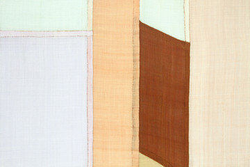 	Patchwork background of ramie fabric stitched by hand.