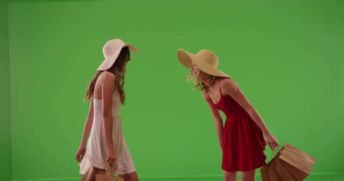 Couple of white girls twirling in summer dresses after shopping on greenscreen