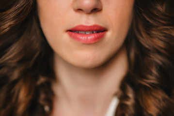 peaked attractive girl lips with red lipstick close up