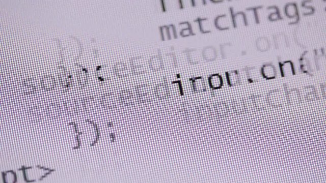 Website development. Closeup of HTML, CSS, JavaScript and PHP code fast scrolling over white background on computer screen