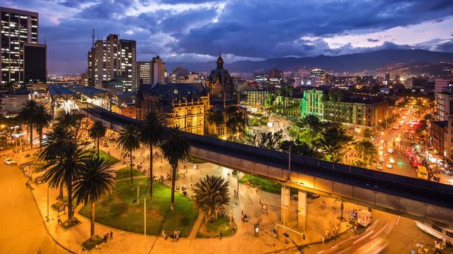 Medellin, Colombia, time lapse view of downtown buildings and Plaza Botero square at dusk. Zoom in.