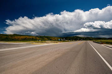 Empty open highway and stormy clouds in Wyoming