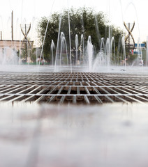 Water from a fountain in the park as a background