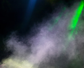 Multi-colored smoke at the concert at night
