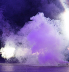 Multi-colored smoke at the concert at night