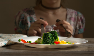 Broccoli with vegetables on a white plate. Vegetarianism. Healthy food.