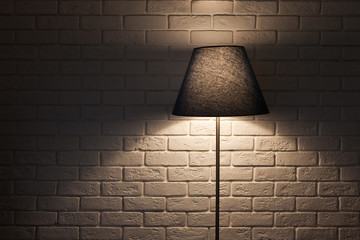 floor lamp on the background of a textured wall of white brick. wooden shelf. texture, background,...
