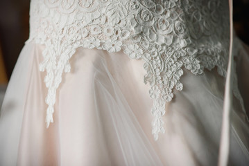 Fototapeta na wymiar wedding white silk dress with beautiful lace close-up