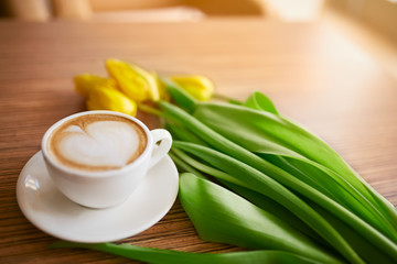 Coffe with tulips lying on the table, Spring concept, women`s day.