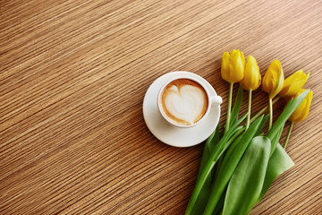 Coffe with tulips lying on the table, Spring concept, women`s day.