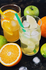 Pineapple and orange juice with pieces of fruit in a glass.