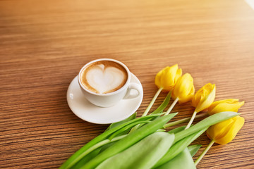 Coffe with tulips lying on the table, Spring concept, women`s day.
