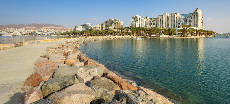 Morning view on Eilat - a famous Israeli city with beautiful sandy beaches, hot sun and clear blue skies, surrounded by stunning mountains and desert scenery