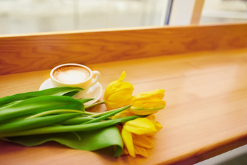 Coffe with tulips lying on the table, Spring concept, women`s day.