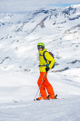 Photo of sporty man wearing helmet skiing against backdrop of snowy mountains