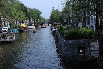 Fototapeta na wymiar Amsterdam cannal with boats and houses