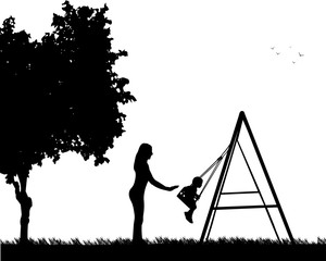 Mother swinging child on a swing in the park, one in the series of similar images silhouette