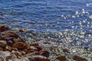 The sea view. Calm sea and large stones. Transparent water of the Adriatic Sea. Montenegro