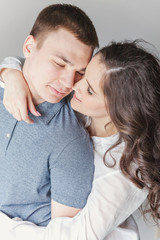 Couple in love having nice time together. Young happy woman hugging her handsome boyfriend. Cheerful casual people students having hopes, dreams, goals, bride and groom with family wants and aspiratio