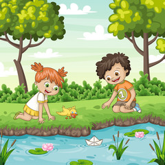 Two children play with a boat by al lake