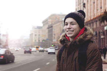 happy young man on the street of the city