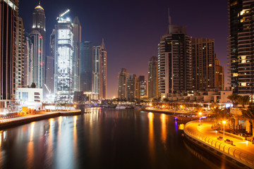 Fototapeta na wymiar DUBAI, UAE - FEBRUARY 2018: View of modern skyscrapers at night in Dubai Marina in Dubai, UAE.