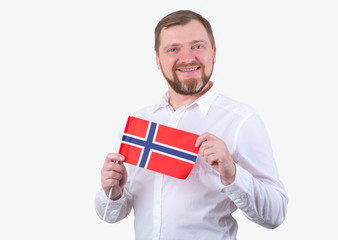 Adult man with a beard in a white shirt holds the flag of Norway.