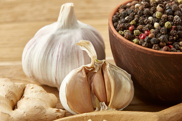 Composition of powder spices on spoon and different sorts of spicies on wooden table background,...