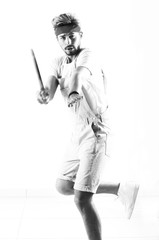 Handsome young sportsman holding racket isolated on white