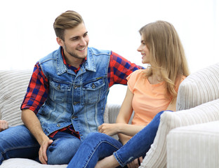 group of young people talking sitting on the couch