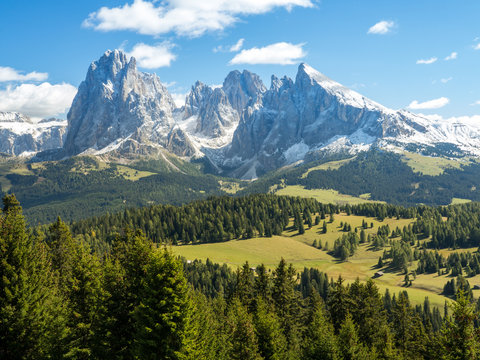 Blue sky with clouds, green grass. View into the Val Gardena near Ortisei,South Tirol,Italy. September, 2017