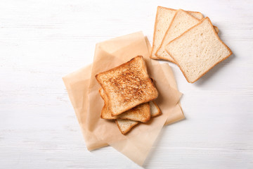 Tasty toasted bread on wooden table